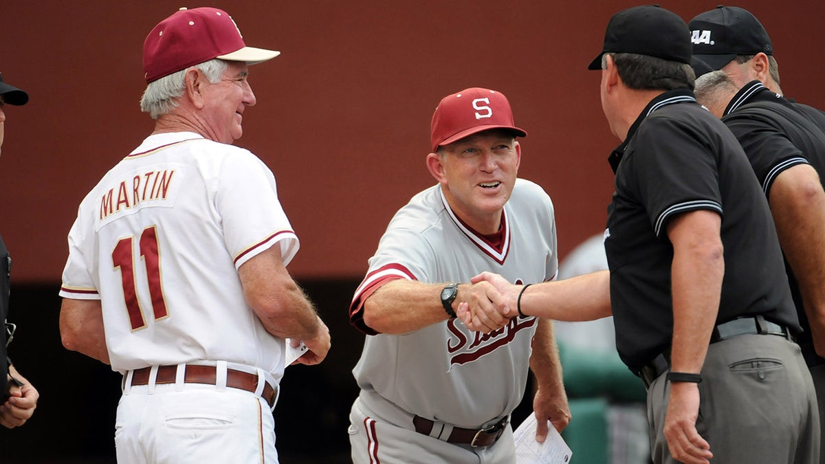 Mark Marquess shakes hands with umpire