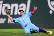 Texas Rangers right fielder Alejandro Osuna makes a sliding catch on a line drive off the...