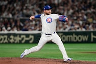 Chicago Cubs relief pitcher Ryan Brasier throws to the Los Angeles Dodgers in the ninth...