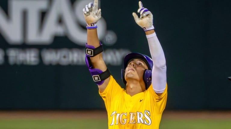 LSU's Derek Curiel points skyward after hitting a double against...