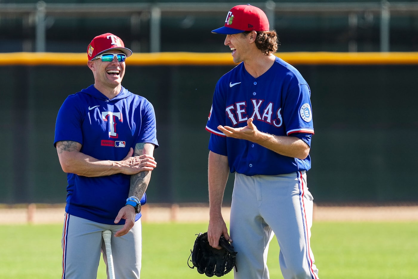 Texas Rangers pitcher Jacob Degrom (right) laughs with manager Skip Schumaker during a...