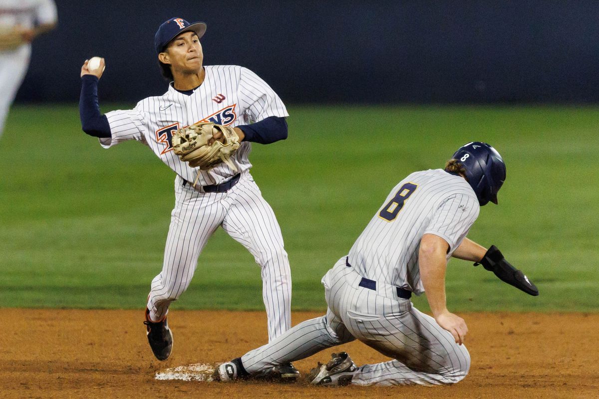 CSUF infielder Eli Lopez (1) attempts to finish the double play during an NCAA Baseball game against the CBU Lancers on February 13, 2026 in Fullerton, California.
