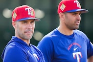Texas Rangers manager Skip Schumaker watches pitchers take fielding practice with bench...