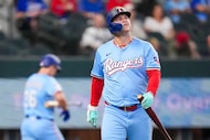 Texas Rangers designated hitter Joc Pederson heads back to the dugout after striking out to...