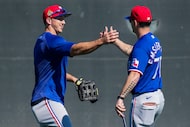 Texas Rangers outfielder Wyatt Langford (left) greets minor league coach Kawika Emsley-Pai...