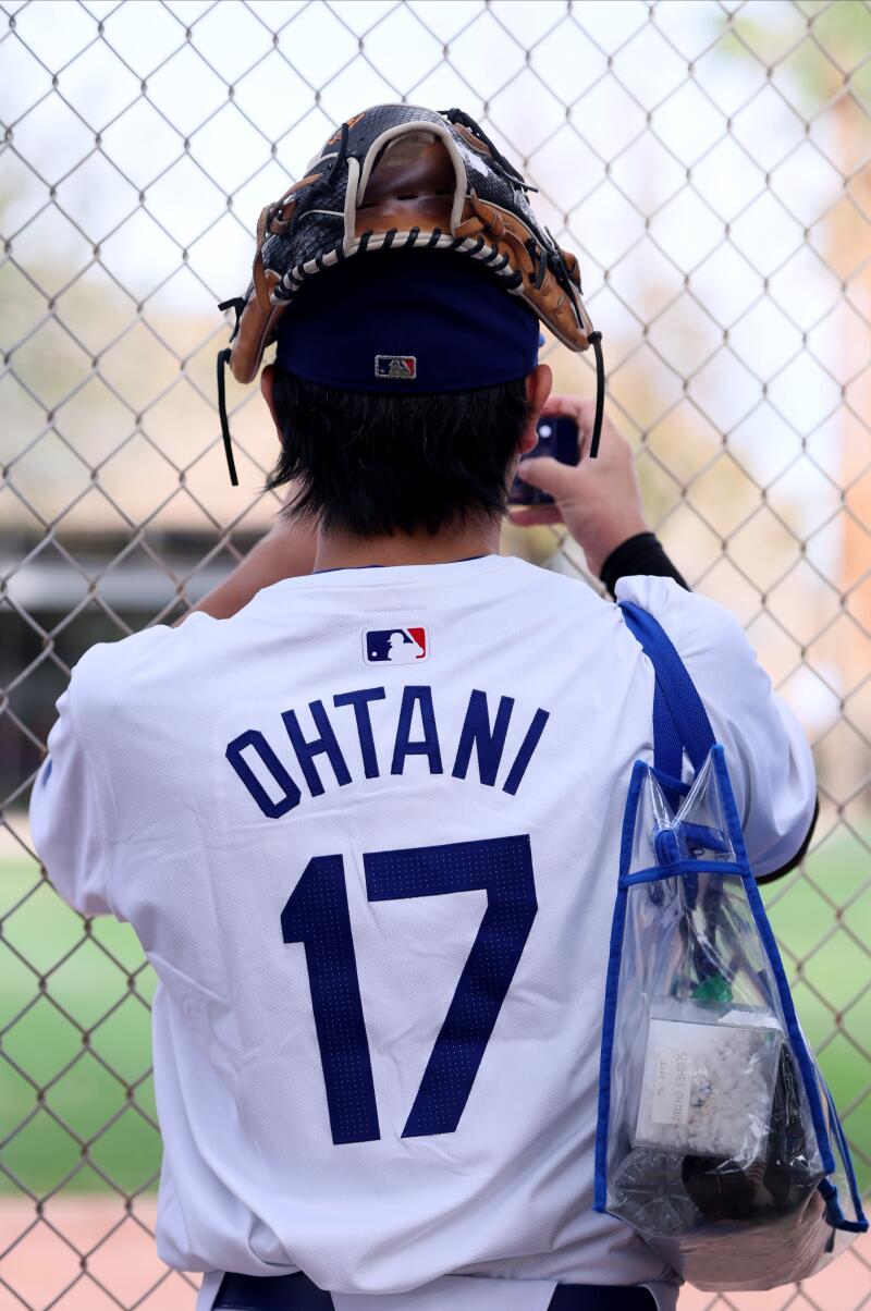 Yoshiki Ideguchi, who traveled from Tokyo, watches at Dodgers spring training at Camelback Ranch in Arizona Monday.
