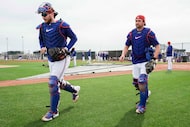 Texas Rangers catchers Danny Jansen (left) and Kyle Higashioka walk between drills during a...