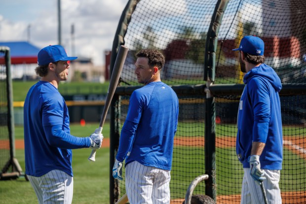 Nico Hoerner, Alex Bregman, and Dansby Swanson talk during batting practice at spring training at Sloan Park on Tuesday, Feb. 17, 2026, in Mesa, Ariz. (Armando L. Sanchez/Chicago Tribune)
