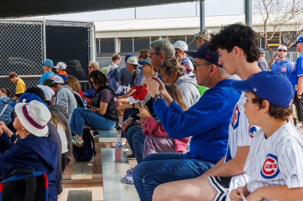 Fans watch Eli Morgan pitch during live batting practice on the first day of the Cubs full-squad workout at spring training at Sloan Park on Feb. 16, 2026, in Mesa, Ariz. (Armando L. Sanchez/Chicago Tribune)