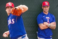 Texas Rangers manager Skip Schumaker watches pitcher Cal Quantrill throw in the bullpen...