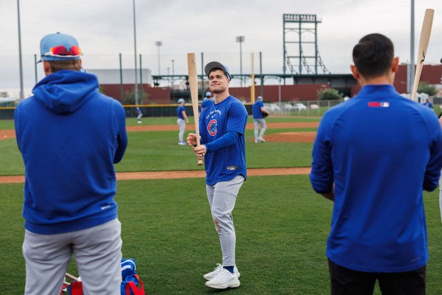Matt Shaw stands with other players before warming up during the first day of the Cubs full-squad workout at spring training at Sloan Park on Feb. 16, 2026, in Mesa, Ariz. (Armando L. Sanchez/Chicago Tribune)
