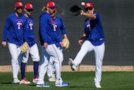 Texas Rangers outfielder Wyatt Langford makes a catch in a fielding drill during a spring...