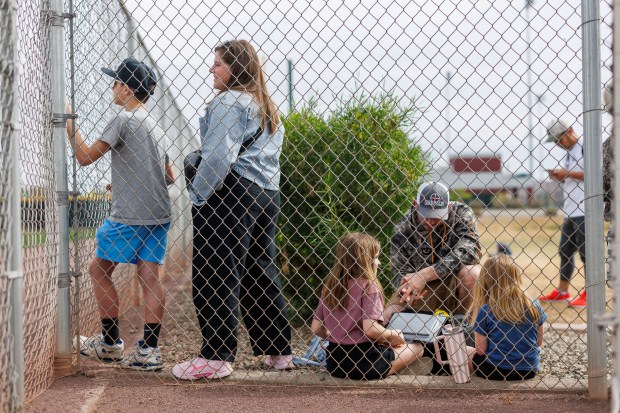 From left, Connor Anderson, 11, his mother Molly Anderson, her husband Joe Anderson, and their daughters Callie Anderson, 7, and Crosbee Anderson, 4, watch players practice during the first day of the Cubs full-squad workout at spring training at Sloan Park on Feb. 16, 2026, in Mesa, Ariz. (Armando L. Sanchez/Chicago Tribune)