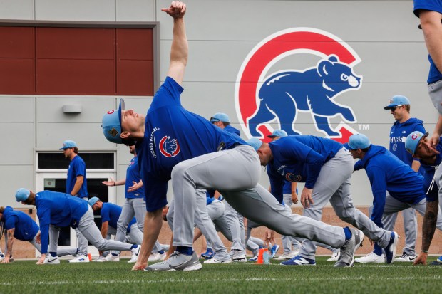 Players stretch during the first day of the Cubs full-squad workout at spring training at Sloan Park on Feb. 16, 2026, in Mesa, Ariz. (Armando L. Sanchez/Chicago Tribune)