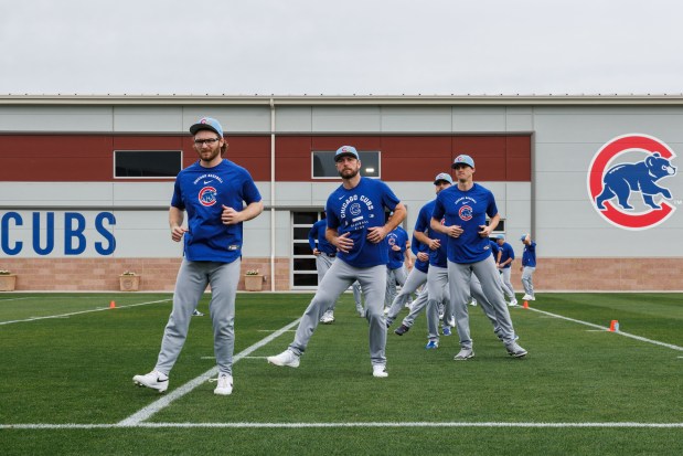 Players stretch during the first day of the Cubs full-squad workout at spring training at Sloan Park on Feb. 16, 2026, in Mesa, Ariz. (Armando L. Sanchez/Chicago Tribune) 
