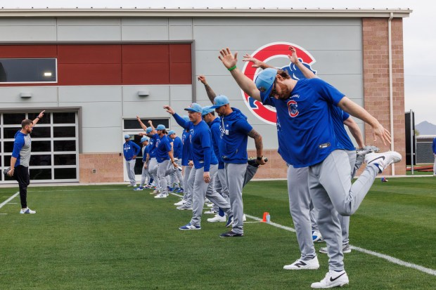 Players stretch during the first day of the Cubs full-squad workout at spring training at Sloan Park on Feb. 16, 2026, in Mesa, Ariz. (Armando L. Sanchez/Chicago Tribune)