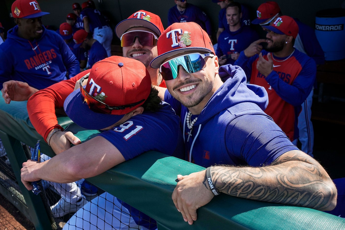 Texas Rangers infielder Cody Freeman puts his arm around infielder Cameron Cauley (91) as he...