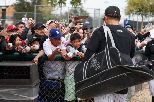 Fans crowd near the fence as they try to get autographs from new White Sox infielder Munetaka Murakami during spring training at Camelback Ranch on Monday, Feb. 16, 2026, in Glendale, Ariz. (Eileen T. Meslar/Chicago Tribune)