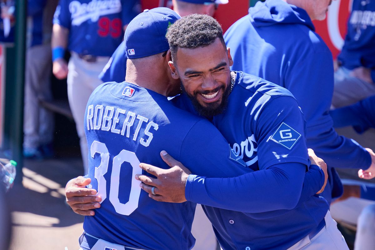 The Los Angeles Dodgers manager Dave Roberts (30) and right fielder Teoscar Hernández (37) celebrate during a spring training game against the Los Angeles Angels, February 21st, 2026 in Tempe Arizona.