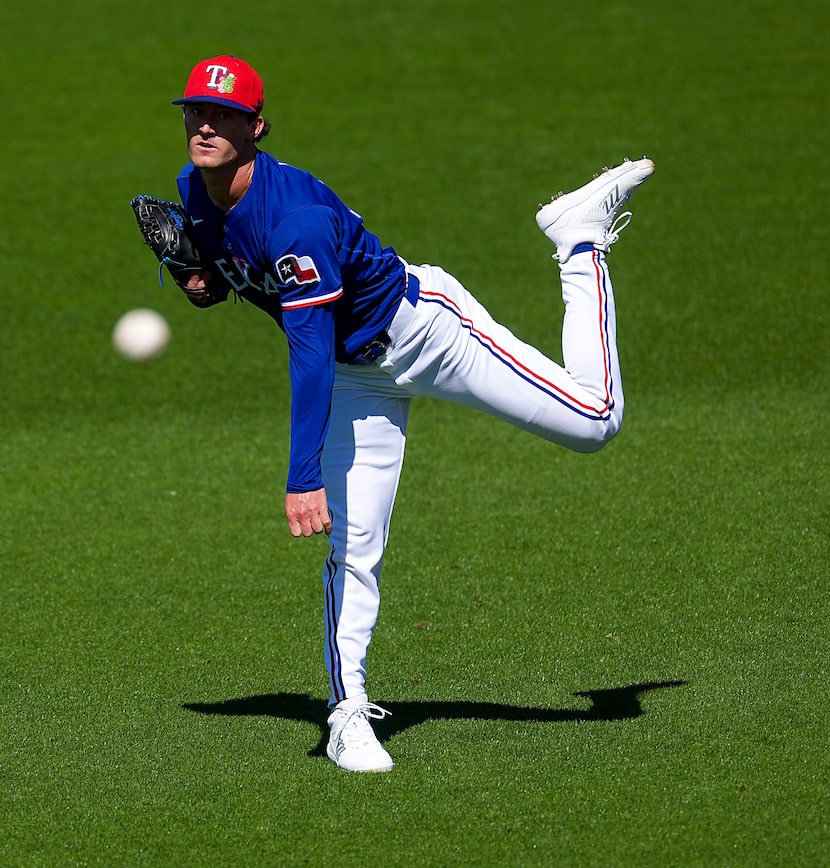 Texas Rangers pitcher Jacob Latz warms up before a spring training game against the Arizona...