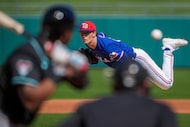 Texas Rangers pitcher Jacob Latz delivers during the second inning of a spring training game...