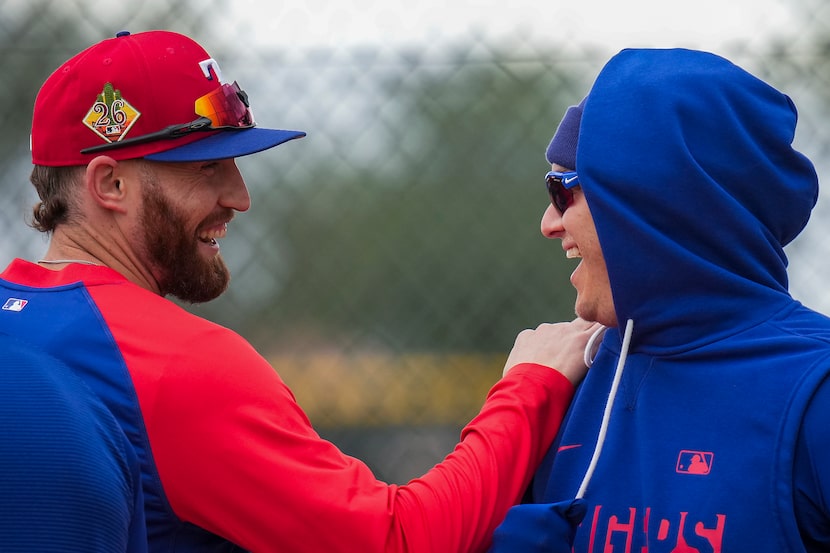 Texas Rangers outfielder Brandon Nimmo (left) laughs with infielder Joc Pederson during a...