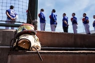 Texas Rangers players line up for the national anthem before of a spring training game...