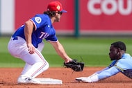 Milwaukee Brewers outfielder Louis Lara is caught stealing as Texas Rangers second baseman...