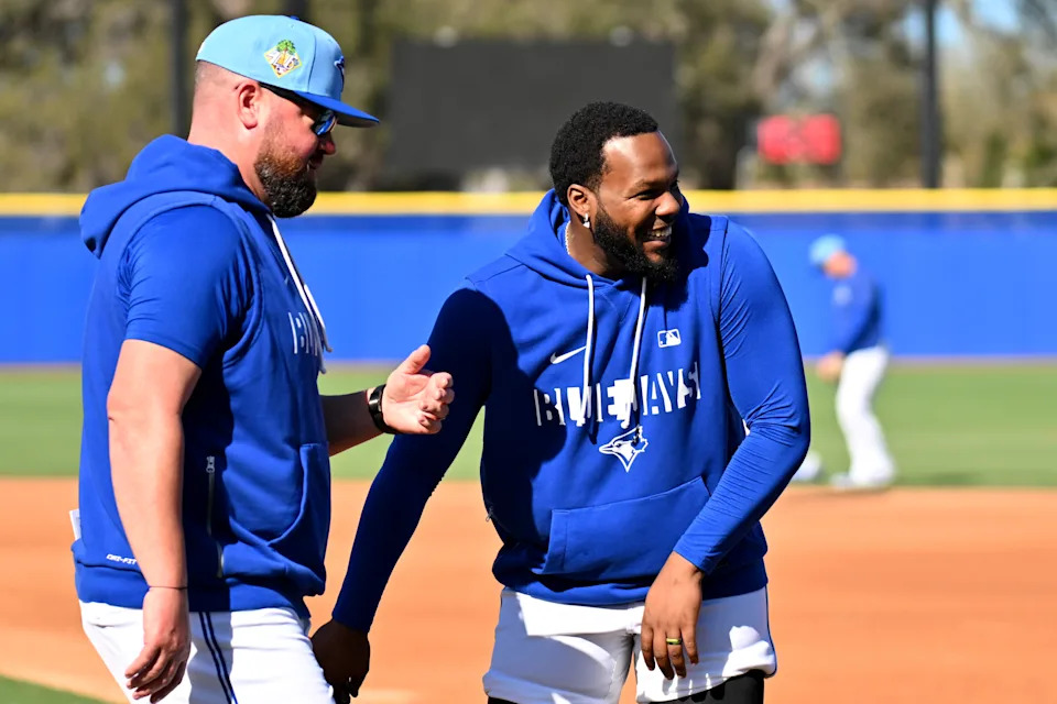 Feb 17, 2026; Dunedin, FL, USA; Toronto Blue Jays infielder Vladimir Guerrero Jr. (27) talks with manager John Schneider (14) during spring training at Bobby Mattick Training Center at Englebert Complex. Mandatory Credit: Jonathan Dyer-Imagn Images