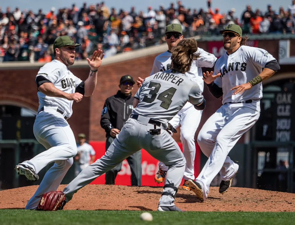 May 29, 2017; San Francisco, CA, USA; San Francisco Giants second baseman Joe Panik (12) and first baseman Michael Morse (38) join the mound as relief pitcher Hunter Strickland (60) fights Washington Nationals right fielder Bryce Harper (34) during the eighth inning at AT&T Park. Mandatory Credit: Kelley L Cox-USA TODAY Sports
