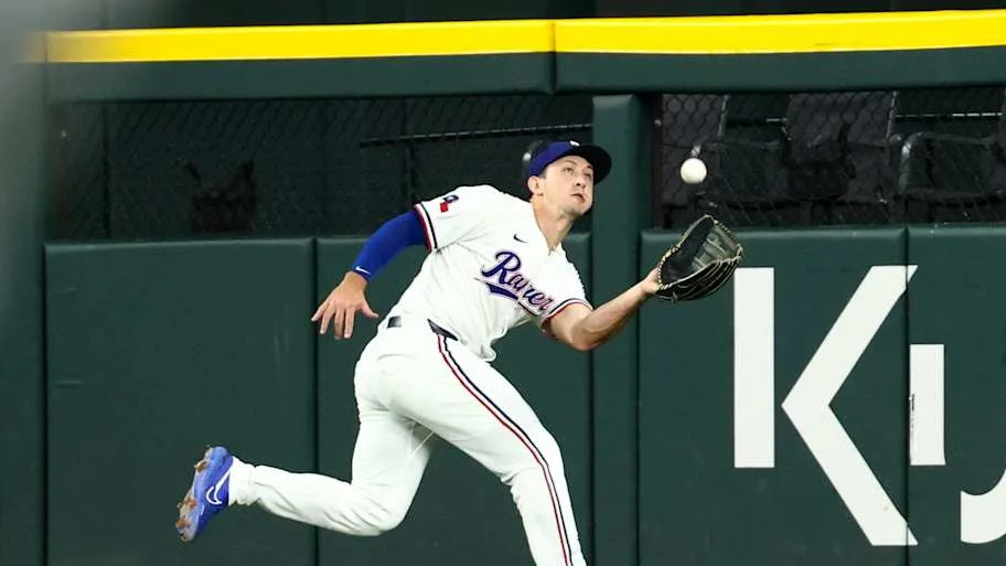 Texas Rangers center fielder Wyatt Langford makes a running catch.