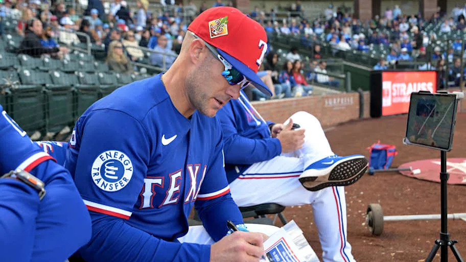 Texas Rangers manager Skip Schumaker checks his line up card.