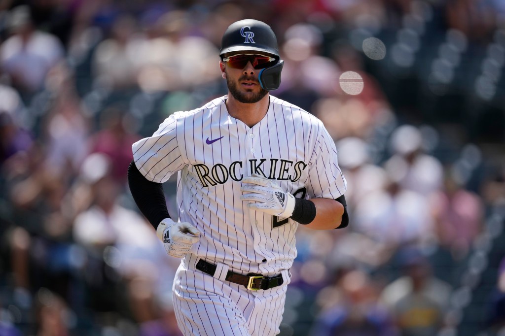 Colorado Rockies' Kris Bryant heads to first base after drawing a walk with the bases loaded to force in a run against San Diego Padres starting pitcher Blake Snell in the fourth inning of a baseball game Thursday, July 14, 2022, in Denver.