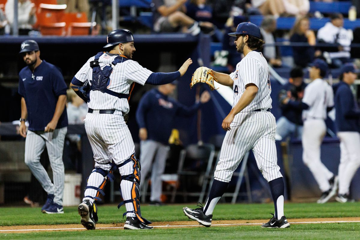 CSUF Titans pitcher Moriah Negrete (4) and catcher Max Ortega (36) react after an inning-ending strikeout during an NCAA Baseball game against the CBU Lancers on February 13, 2026 in Fullerton, California.