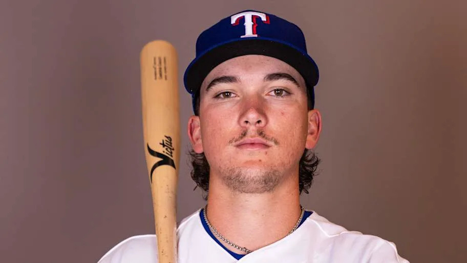 Texas Rangers infielder Cameron Cauley poses with a bat on his shoulder.