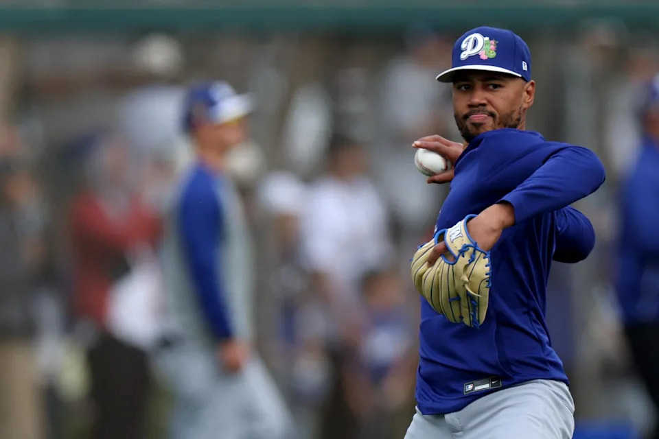 Mookie Betts throws a ball during Dodgers spring training at Camelback Ranch in Arizona Monday.