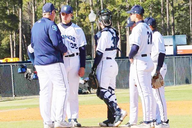 St. Johns River State College baseball coach Ross Jones (left) talks with starting pitcher Gabe Barker (35) during Sunday’s 18-14 Vikings win over South Georgia State. (RITA FULLERTON / Special to the Daily News)
