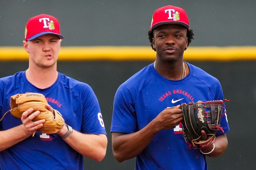 Texas Rangers infielder Sebastian Walcott (right) and third baseman Josh Jung participate in...