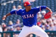 Texas Rangers pitcher Kumar Rocker delivers during the second inning of a spring training...