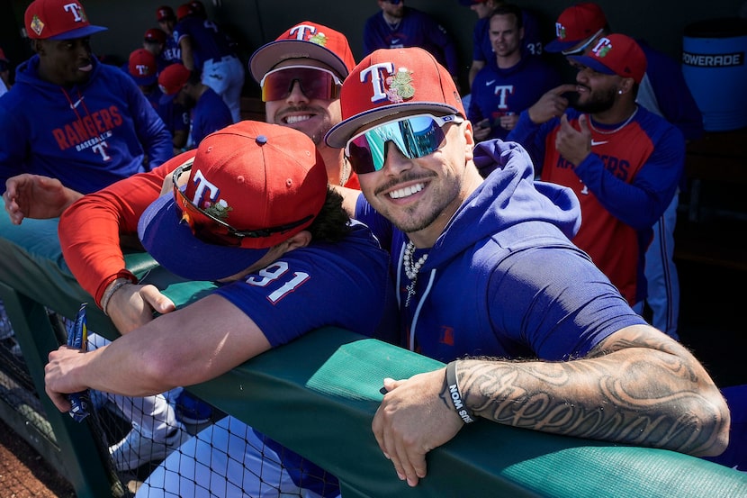 Texas Rangers infielder Cody Freeman puts his arm around infielder Cameron Cauley (91) as he...