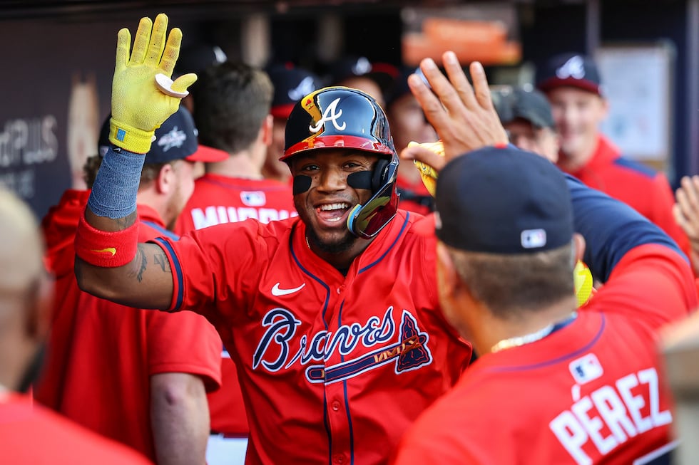 Atlanta Braves' Ronald Acuna Jr. celebrates in the dugout after hitting a home run in the...