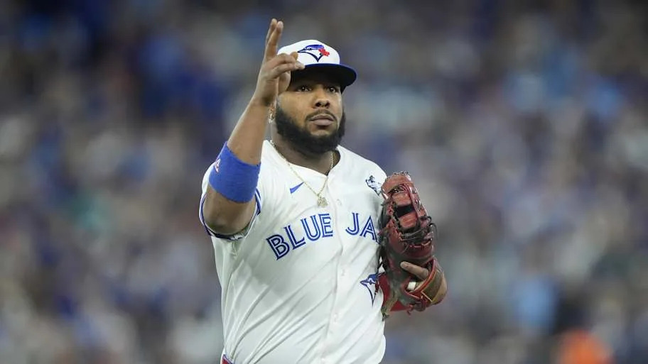 Toronto Blue Jays Vladimir Guerrero Jr. pointing up while wearing his jersey