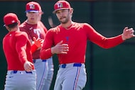Texas Rangers minor league pitcher Paul Bonzagni stretches with teammates during a spring...