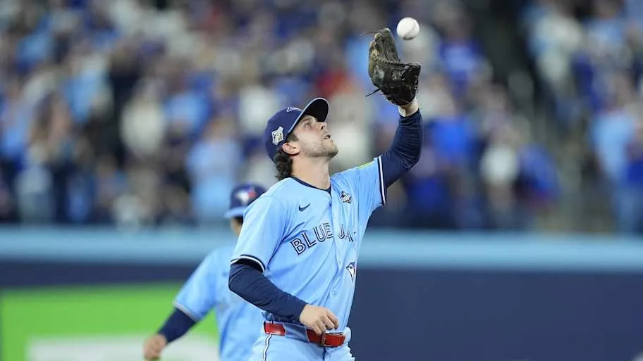Ernie Clement in a baby blue uniform making a catch for an out against the Dodgers second basema
