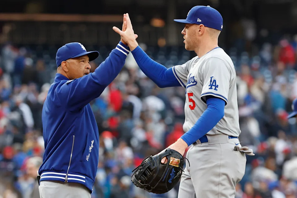Los Angeles Dodgers manager Dave Roberts (30) celebrates with Dodgers first baseman Freddie Freeman (5) after their game against the Washington Nationals at Nationals Park.
