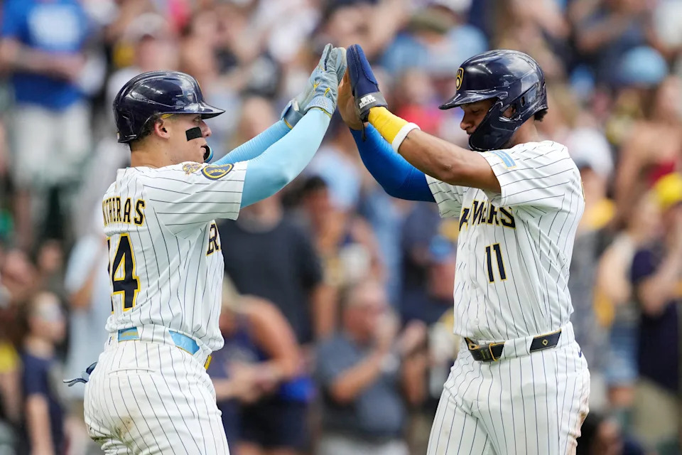 MILWAUKEE, WISCONSIN - JULY 12: William Contreras and Jackson Chourio #11 of the Milwaukee Brewers celebrate after scoring on a double by Andrew Vaughn #28 against the Washington Nationals during the fourth inning at American Family Field on July 12, 2025 in Milwaukee, Wisconsin. (Photo by Patrick McDermott/Getty Images)