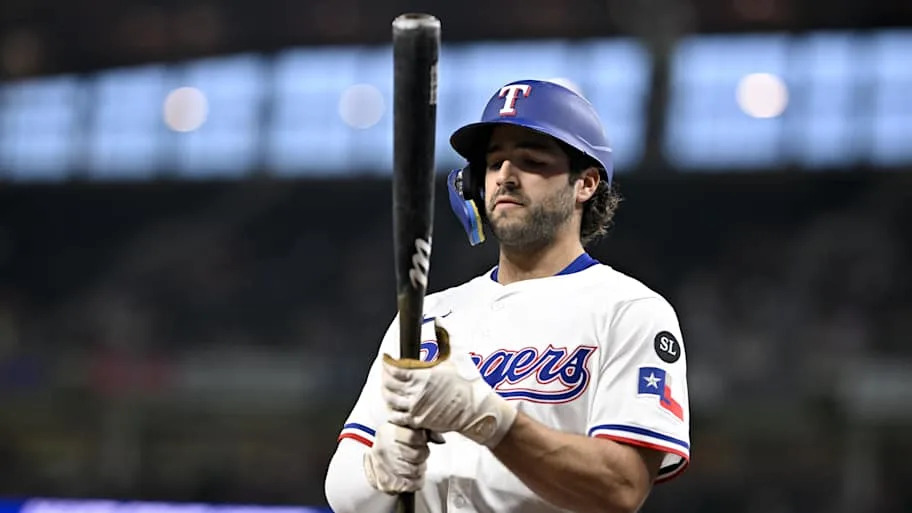 Texas Rangers shortstop Josh Smith holds his bat in the on-deck circle. 