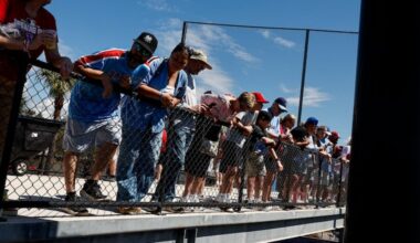 Fans watch the Philadelphia Phillies players warm up before the game.
