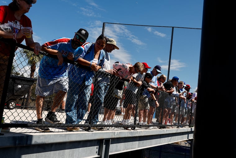 Fans watch the Philadelphia Phillies players warm up before the game.