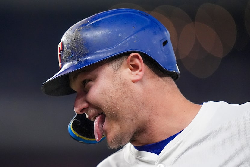 Texas Rangers designated hitter Joc Pederson reacts after legging out an infield single...